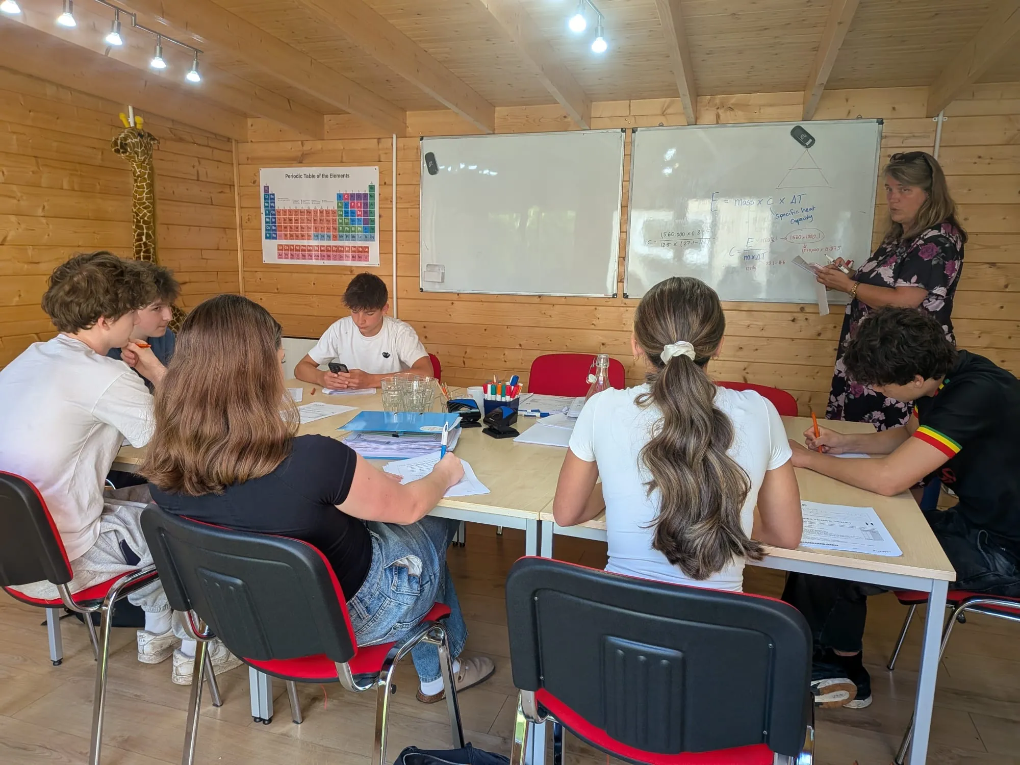 A small-group lesson in the log cabin classroom